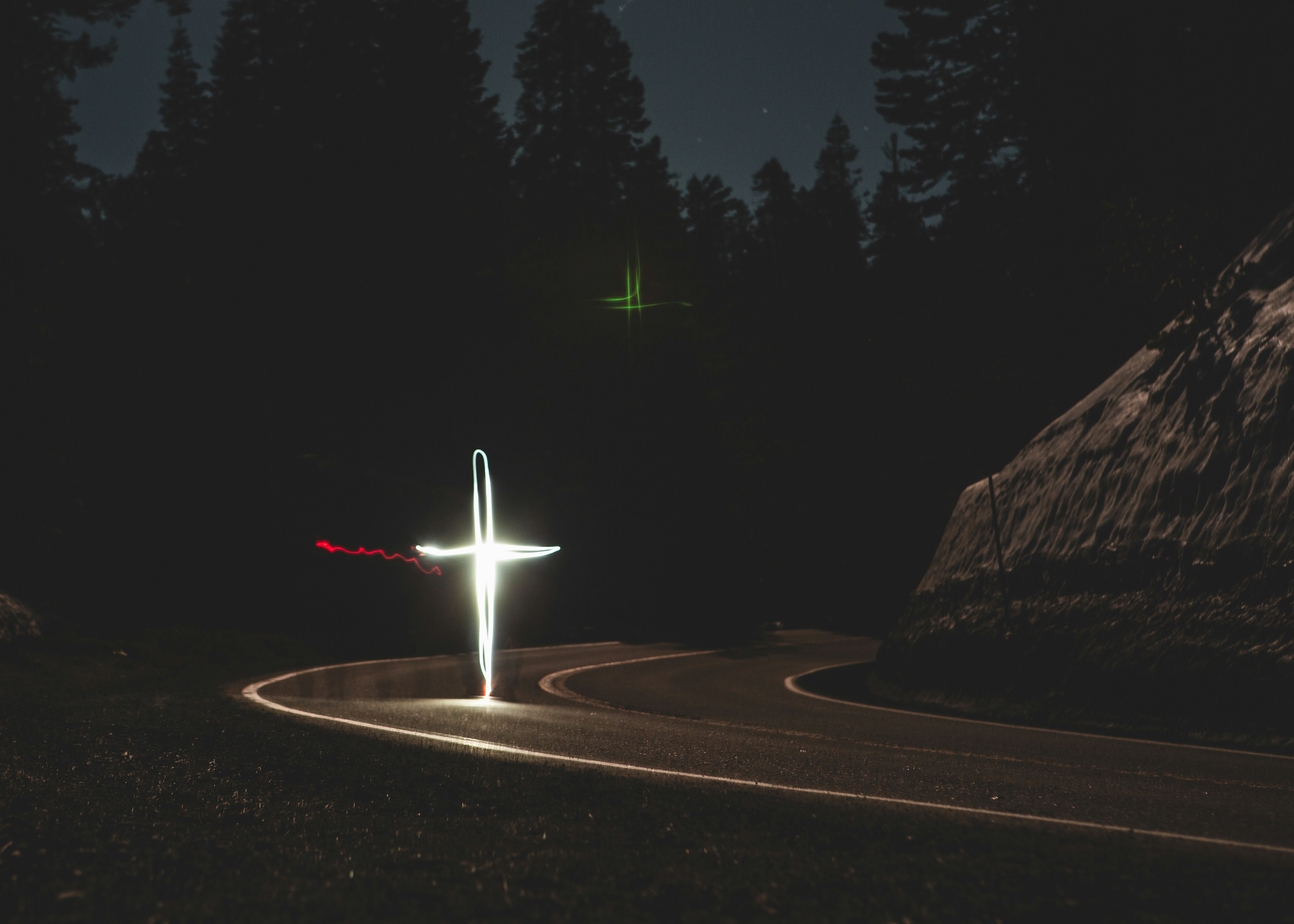 white cross-formed light on road during nighttime