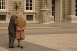 An elderly couple admiring ancient architecture during a tour.