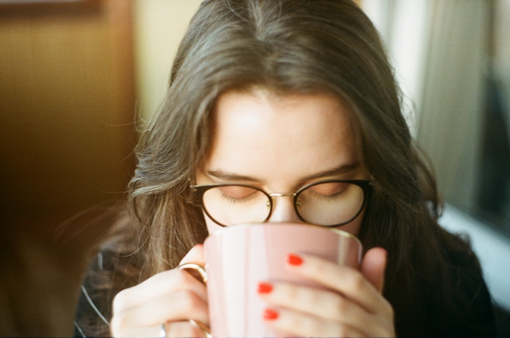 woman carrying ceramic mug