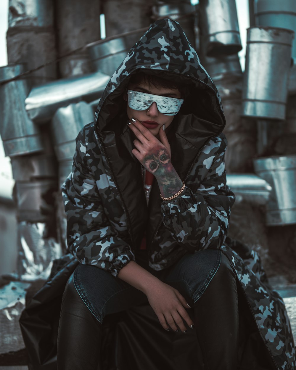 woman in black coat sitting outside during daytime