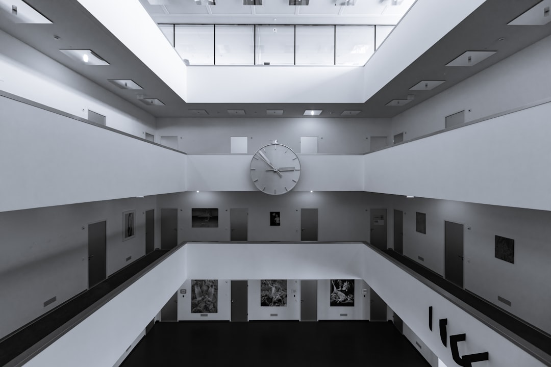 white analog clock inside building