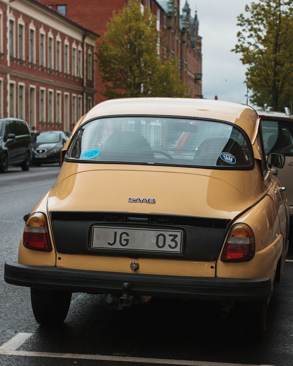 yellow car parked near sidewalk