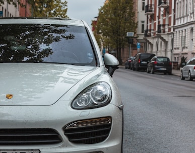 white Porsche SUV on sidewalk