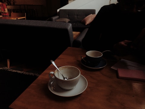 Cozy community cafe room set up for a small meeting with coffee cups on the table.