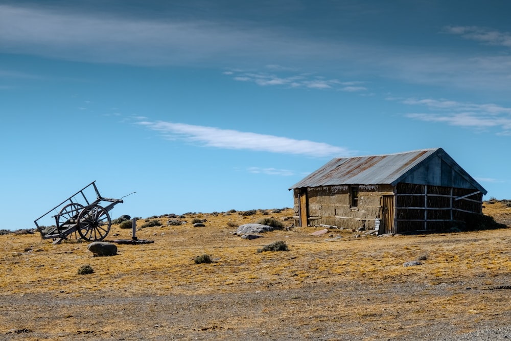 brown trailer beside brown shed during daytime