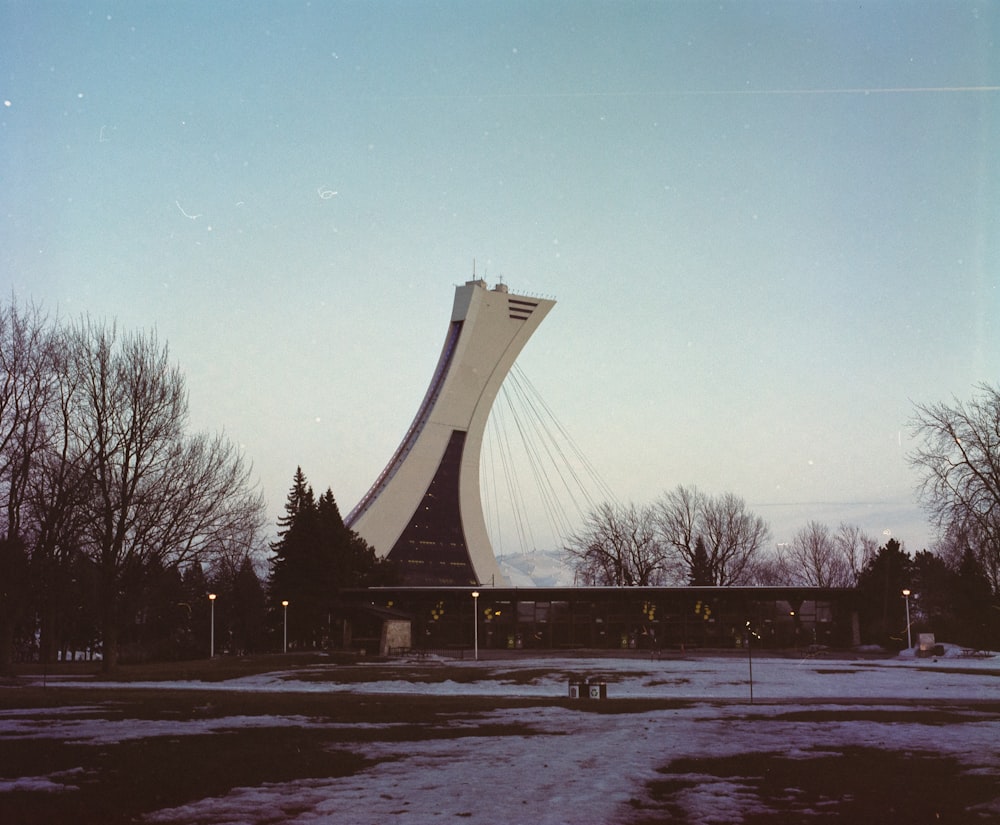 gray concrete tower near bare trees at daytime