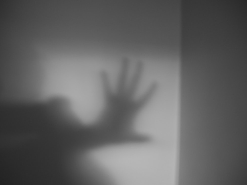 a shadow of a hand on a wall