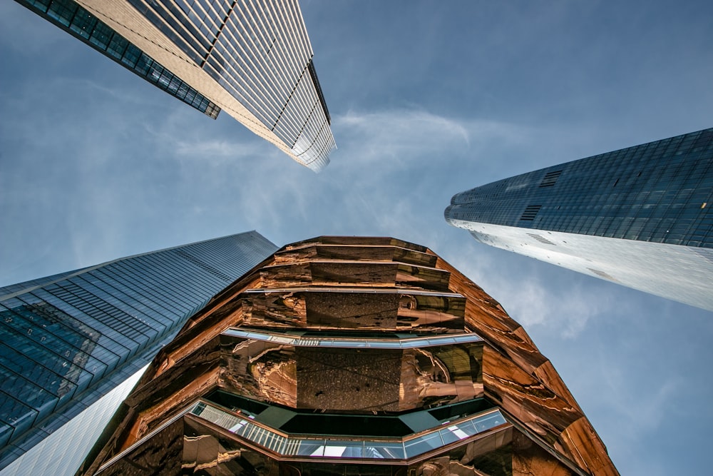 low angle photo of four high rise buildings