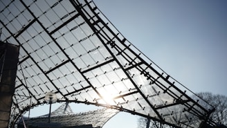 Aluminum terrace structure with modern glass panels under natural sunlight.