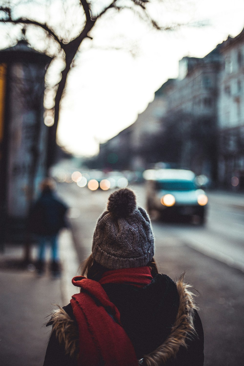 girl wearing bobblehat near the road during daytime