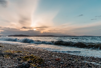 A serene island landscape with gentle waves and a warm sunset.