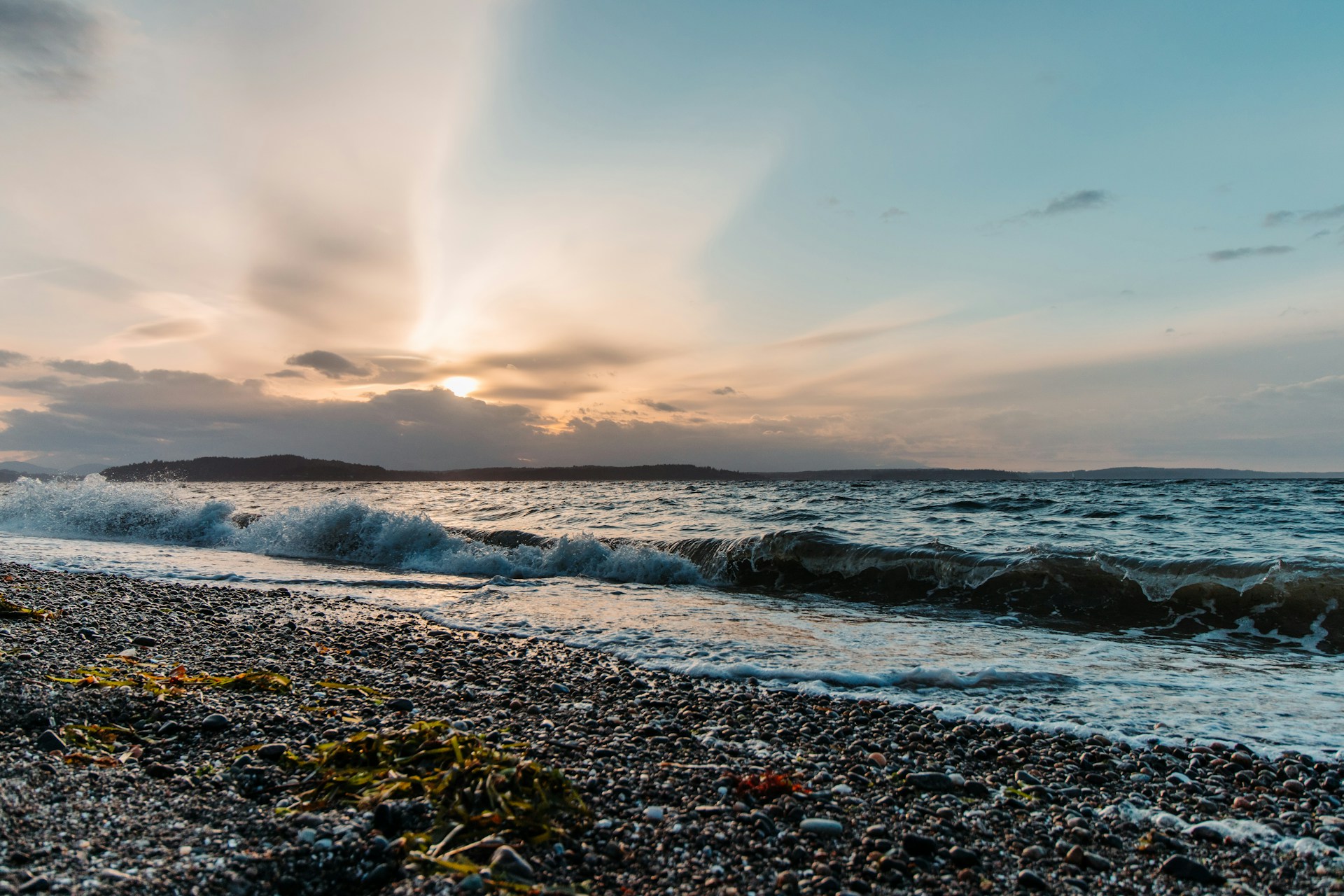 A serene beach at sunset, showcasing the tranquil beauty of Bali, where Igor Tamerlan found his artistic inspiration.