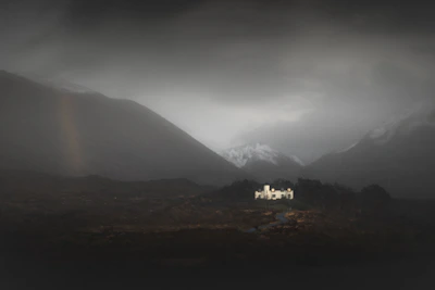 A miniature fantasy castle bathed in moonlight, surrounded by twisted dark trees.