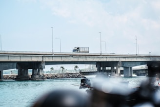 Form traveler carefully positioning concrete molds on a large bridge span
