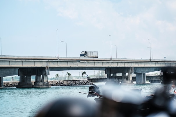 Form traveler carefully positioning concrete molds on a large bridge span