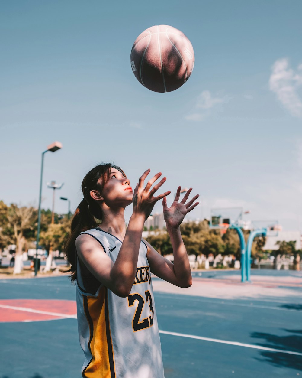 a basketball player reaching up to grab the ball