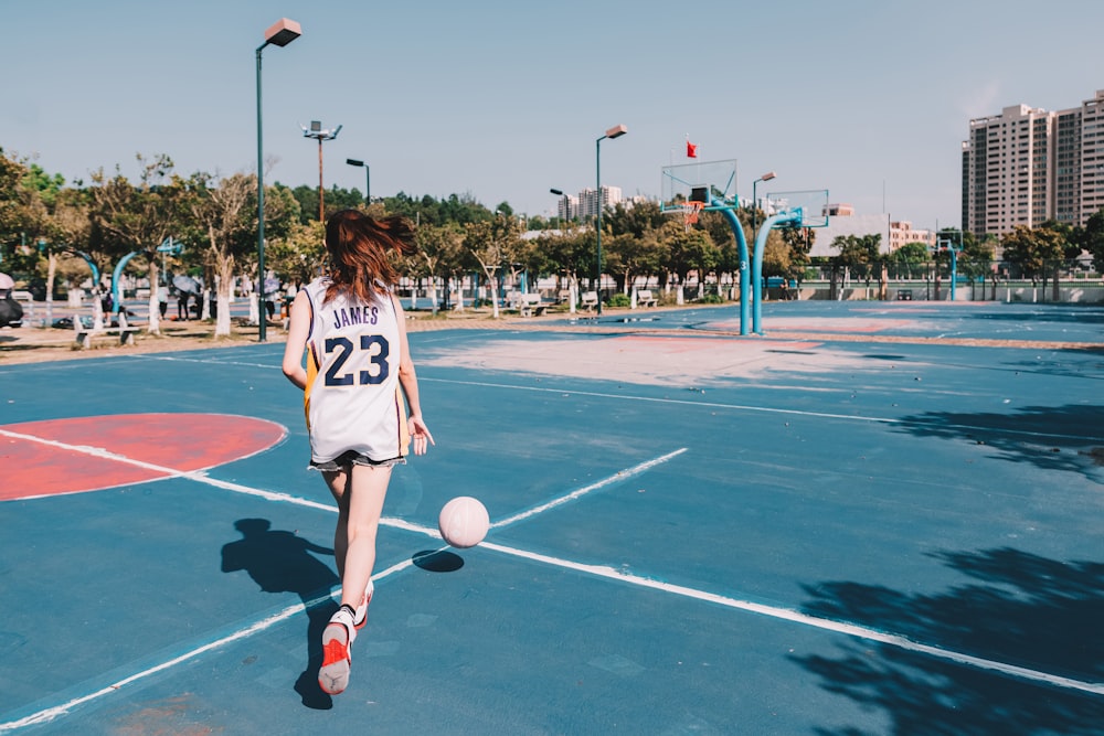 time lapse photography of woman dribbling a ball