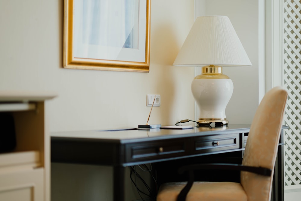 white and gold table lamp on black desk