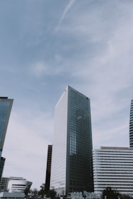 An engineer reviewing blueprints with a modern city skyline in the background.