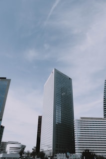 Architects reviewing blueprints with a city skyline background.