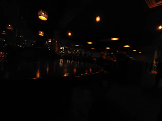 Softly glowing pendant lights casting a warm ambiance over an intimate dining setting.