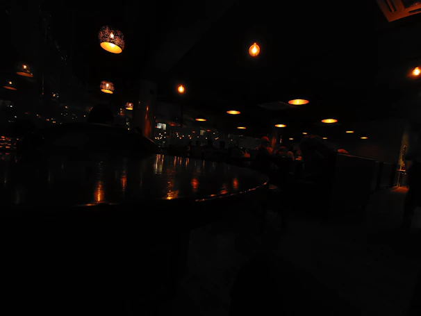 Softly glowing pendant lights casting a warm ambiance over an intimate dining setting.