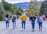 Smiling group of young travelers hiking a scenic mountain trail during a goglobe adventure trip.