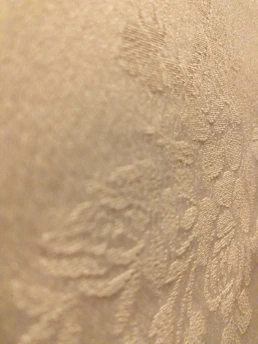 Close-up of soft jacquard fabric with intricate patterns in natural light