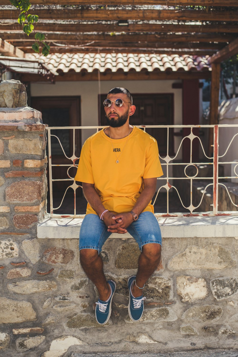 man sitting on concrete wall