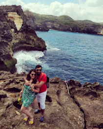 A romantic couple portrait on the Amalfi Coast with pastel cliffs and sea in the background.