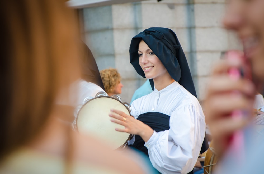 smiling woman holding instrument