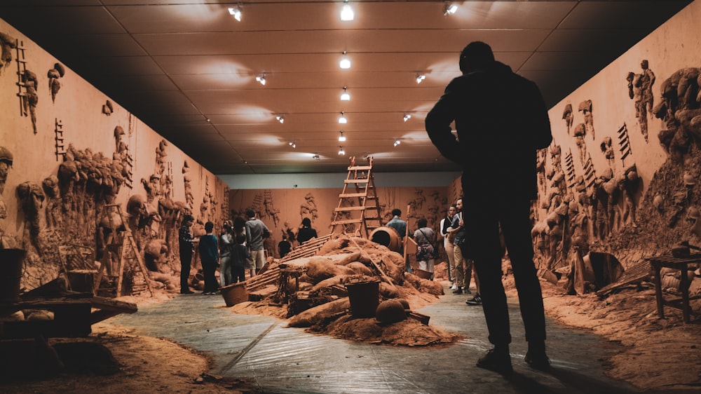 a group of people standing in front of a wall