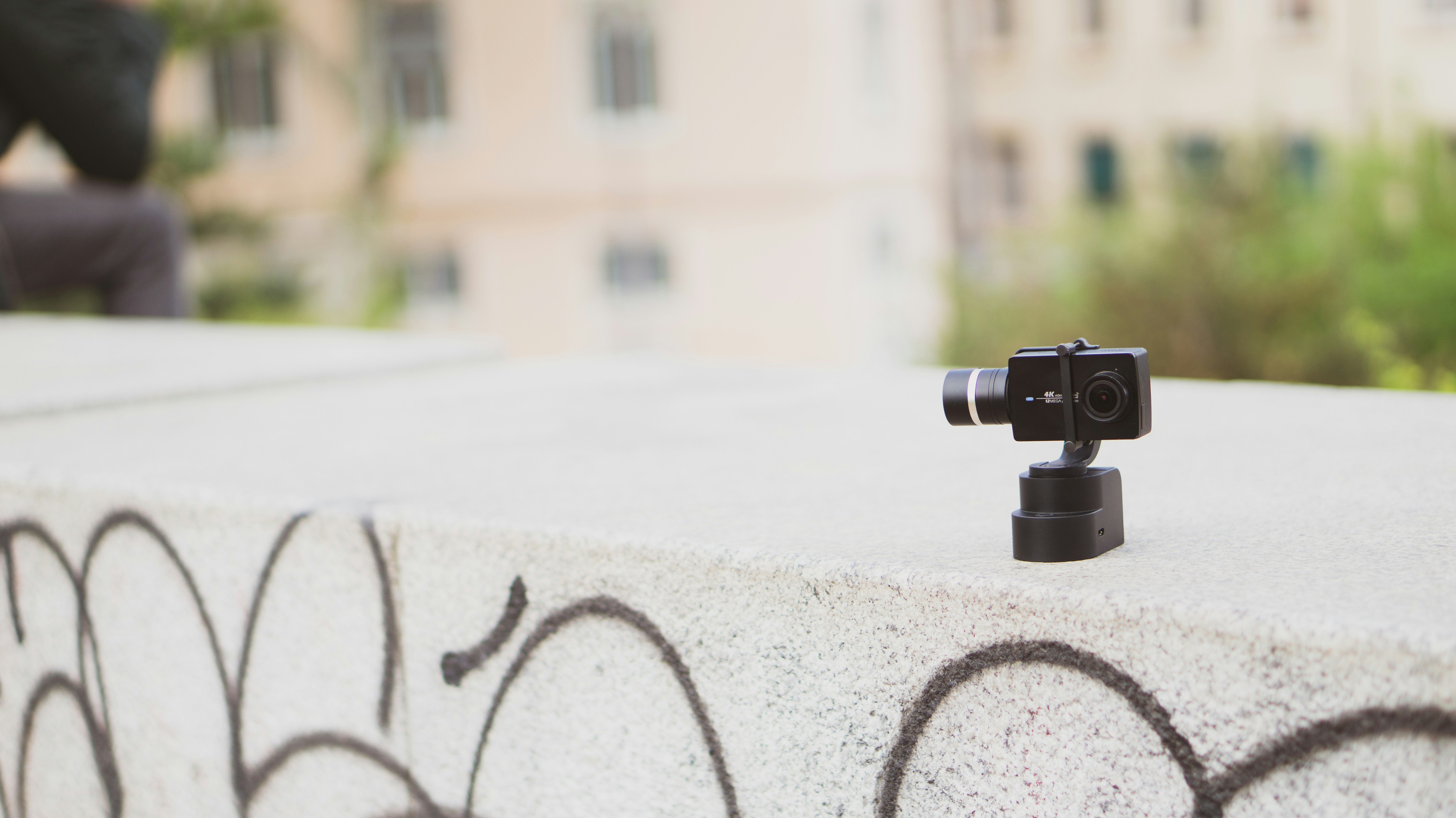 black action camera on gray surface close-up photography