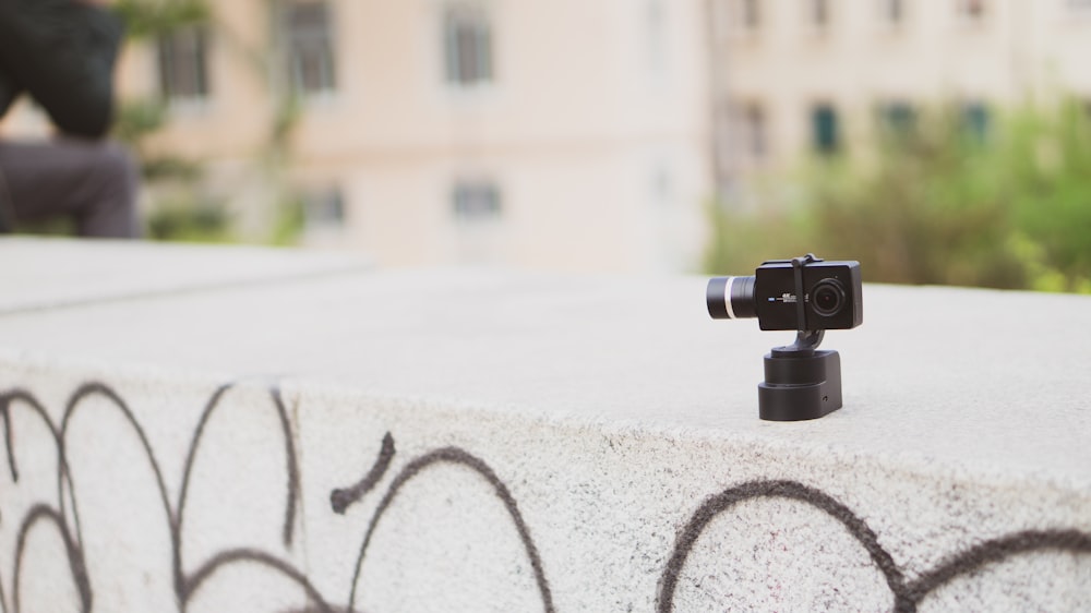 black action camera on gray surface close-up photography