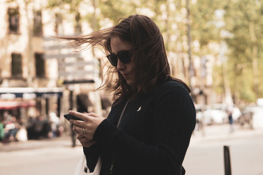 Smiling woman using telehealth app on her phone