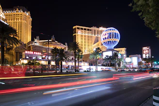A vibrant Las Vegas cityscape at dusk with glowing lights and bustling streets, reflecting the energy of the consulting team.