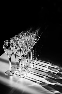 Rows of elegant glassware sparkling on a wooden table ready for a celebration.