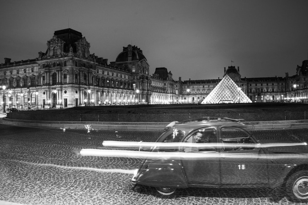 Volkswagen beetle on road in grayscale photo