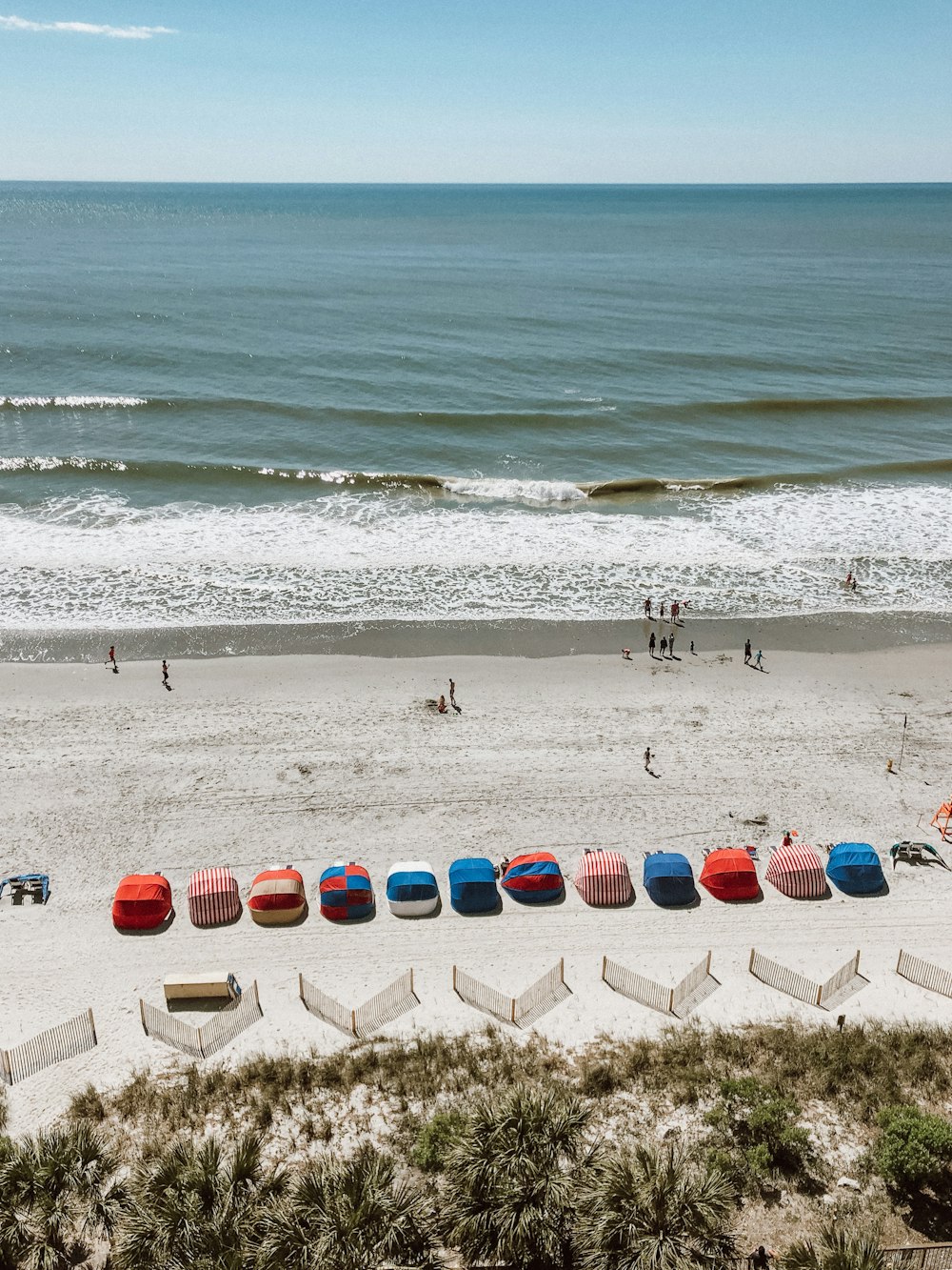 people near seashore viewing calm sea