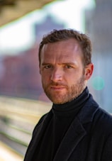 man wearing black notched lapel suit jacket