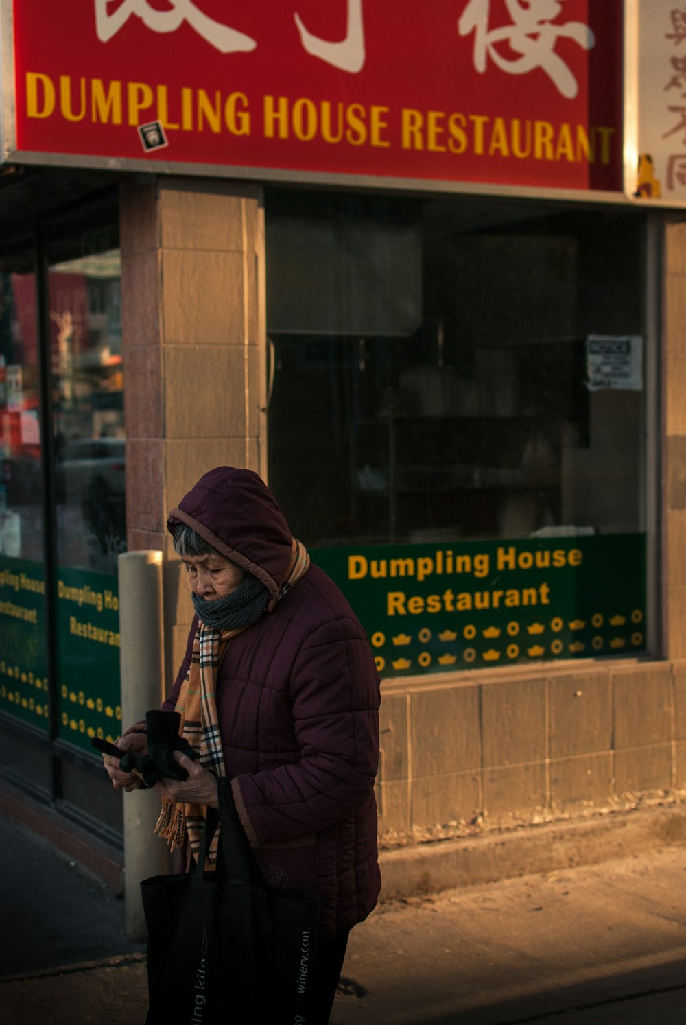 woman passing through dumpling restaurant