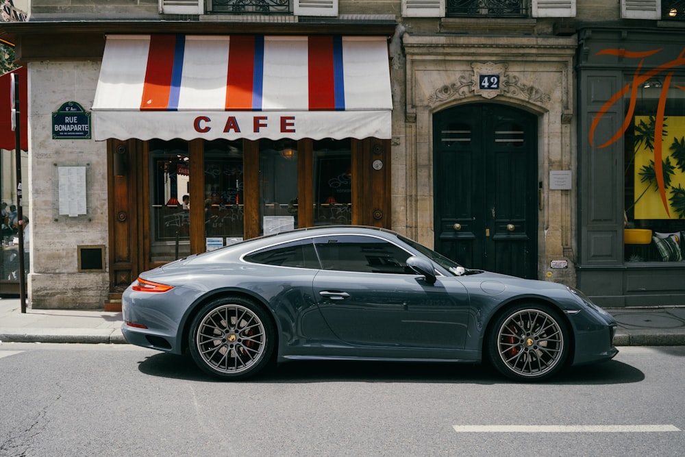 gray coupe parking near Cafe