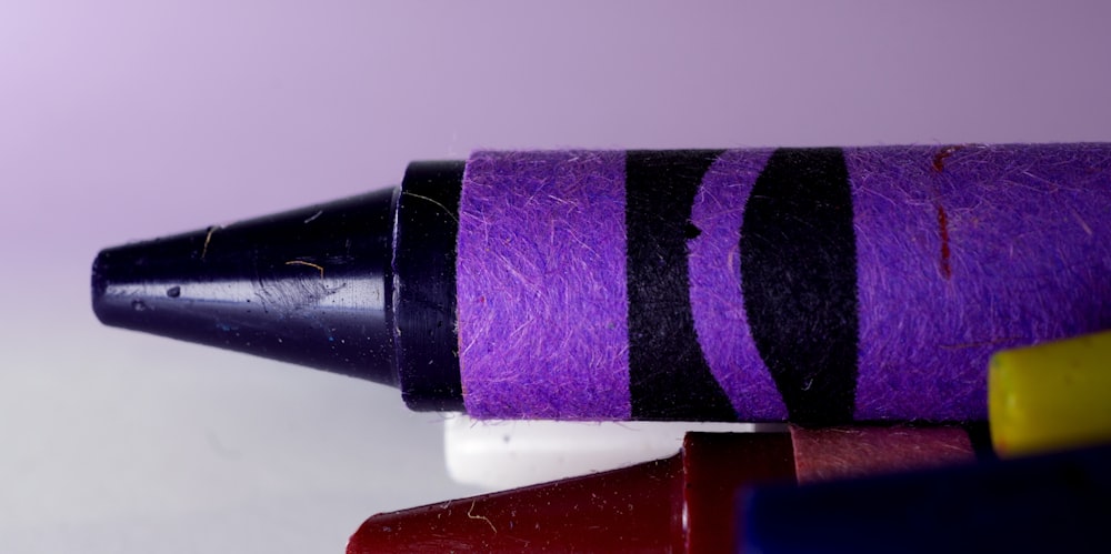 purple crayon in closeup photography