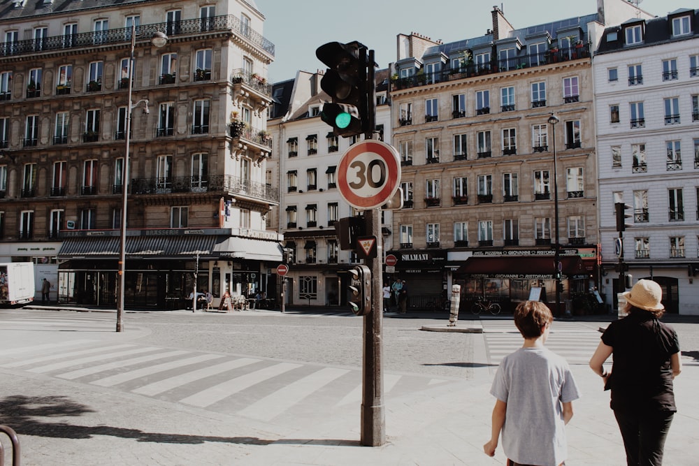 two person walking on street at daytime