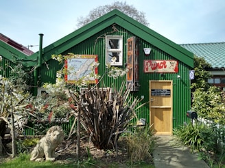 A vibrant photo of the Golden Lion building surrounded by lush greenery.