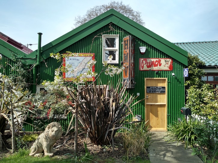 A vibrant photo of the Golden Lion building surrounded by lush greenery.