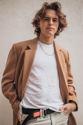 man smirking with left hand in his pants pocket
