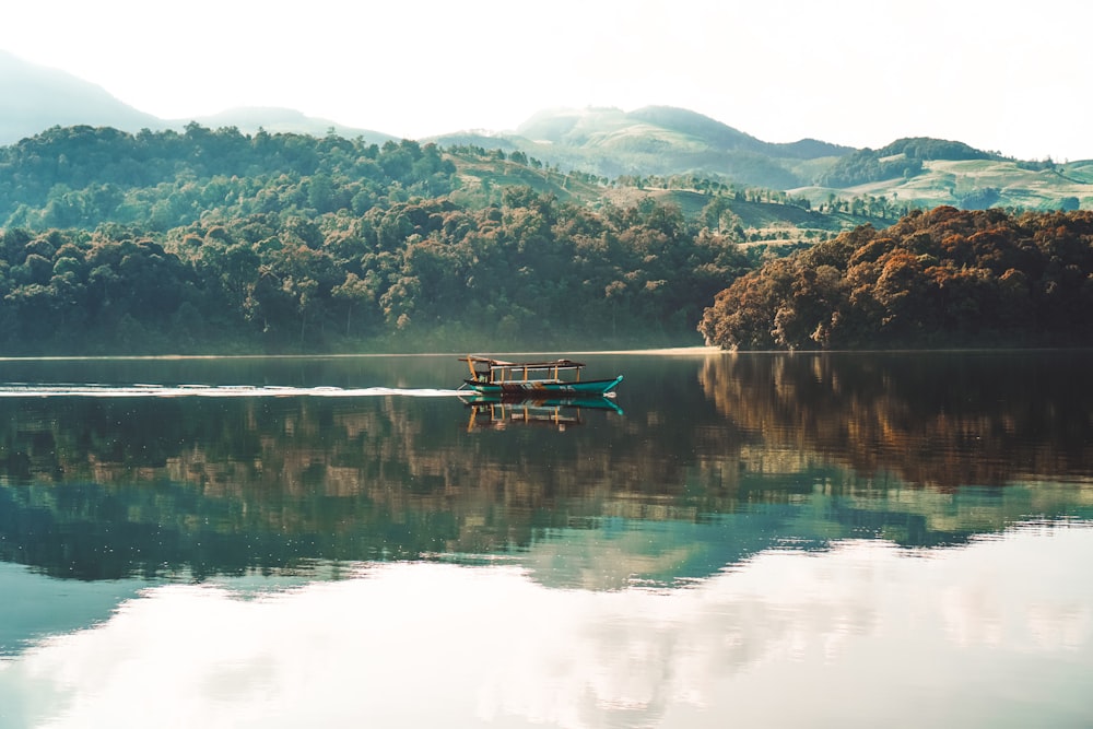 boat on calm body of water at daytime