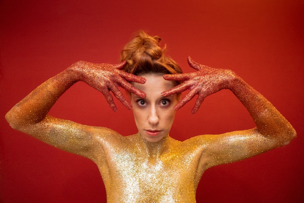 woman with gold and red dust in her body
