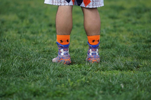 Athletes wearing vibrant sports socks during a run.